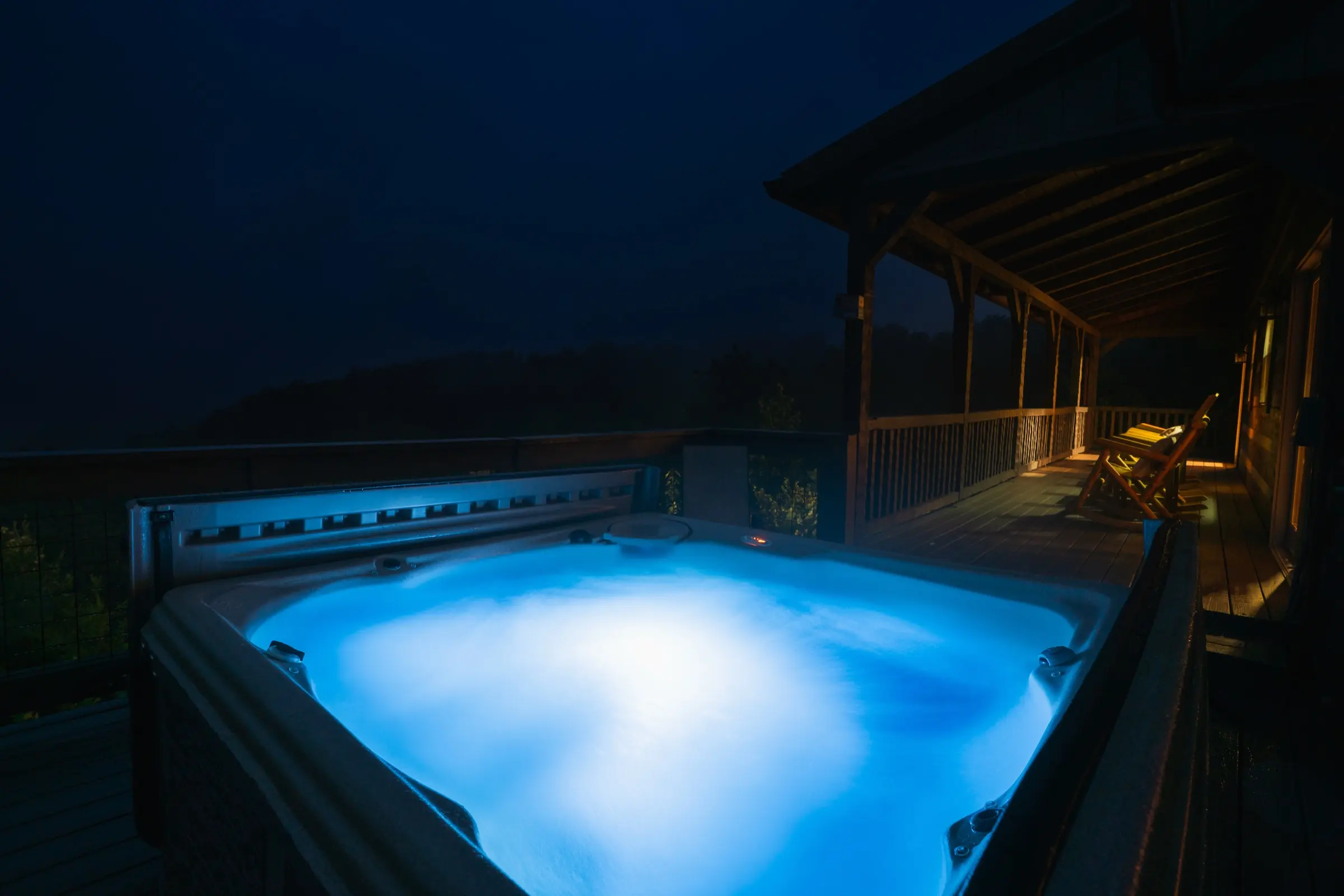 Hot tub at night with mountain backdrop